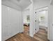 Bright hallway with doors to bedroom and bathroom, featuring wood flooring at 716 W 14Th St, Lakeland, FL 33805