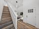 Modern staircase with wood-look laminate treads and white railing at 716 W 14Th St, Lakeland, FL 33805