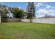 Large fenced backyard with lush green grass at 132 James St, Auburndale, FL 33823