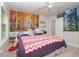 Bedroom with a large tapestry, queen-sized bed, and wood-look floors at 132 James St, Auburndale, FL 33823