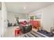Versatile bonus room with a recliner, TV, and ample natural light at 132 James St, Auburndale, FL 33823