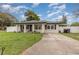 Newly renovated home with a landscaped yard and driveway at 132 James St, Auburndale, FL 33823