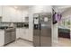 Updated kitchen featuring white cabinets and stainless steel appliances at 132 James St, Auburndale, FL 33823