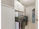 Bright laundry room with washer, dryer, and ample storage at 132 James St, Auburndale, FL 33823
