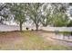 Spacious backyard with two chairs and mature trees at 6867 Shadowcast Ln, Lakeland, FL 33813