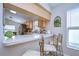 Kitchen features a breakfast bar with seating for two and wood cabinets at 6867 Shadowcast Ln, Lakeland, FL 33813