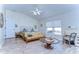 Main bedroom with king size bed and a sitting area at 6867 Shadowcast Ln, Lakeland, FL 33813