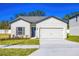 One-story house with gray shutters, attached garage, and well-maintained lawn at 13470 Leaping Water Way, Astatula, FL 34705
