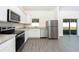 Modern kitchen with stainless steel appliances and granite countertops, overlooking backyard at 13470 Leaping Water Way, Astatula, FL 34705