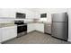 Modern kitchen with stainless steel appliances and granite countertops at 13470 Leaping Water Way, Astatula, FL 34705
