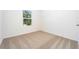 Simple bedroom with carpeted floor and a window at 13474 Leaping Water Way, Astatula, FL 34705