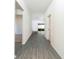 Bright hallway with grey wood-look floors leading to the living room at 13478 Leaping Water Way, Astatula, FL 34705