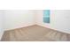 Spacious bedroom with neutral carpeting and a window overlooking the yard at 13486 Leaping Water Way, Astatula, FL 34705