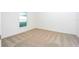 Bright bedroom with neutral carpeting and a large window at 13486 Leaping Water Way, Astatula, FL 34705