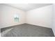 Bright bedroom with grey wood-look floors and a large window at 13486 Leaping Water Way, Astatula, FL 34705