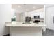 Modern kitchen with white cabinets, granite countertops, and stainless steel appliances at 13486 Leaping Water Way, Astatula, FL 34705