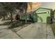 Front view of a green house with a driveway and landscaping at 1111 Royal Ridge Dr, Davenport, FL 33896