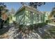 Side view of a light green house with hedges at 1111 Royal Ridge Dr, Davenport, FL 33896