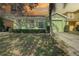 Green house with a green garage door, driveway, and landscaping at 1111 Royal Ridge Dr, Davenport, FL 33896