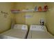 Laundry room with washer, dryer, and shelving at 1111 Royal Ridge Dr, Davenport, FL 33896