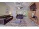 Spacious living room with two leather sofas, coffee table, and large TV at 1111 Royal Ridge Dr, Davenport, FL 33896