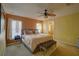 Bright main bedroom featuring a king-size bed and ensuite bathroom access at 1111 Royal Ridge Dr, Davenport, FL 33896