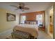 King-size bed, ensuite bathroom access, and large windows with natural light at 1111 Royal Ridge Dr, Davenport, FL 33896