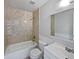 Clean bathroom with bathtub, tiled walls and vanity at 830 Copperleaf Ln, Bartow, FL 33830