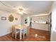 Light and airy dining area with wood flooring and view into kitchen at 1610 Reynolds Rd # 159, Lakeland, FL 33801