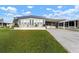 Single-wide manufactured home with carport and spacious lawn at 1610 Reynolds Rd # 159, Lakeland, FL 33801