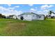 Rear view of manufactured home with grassy yard at 1610 Reynolds Rd # 159, Lakeland, FL 33801