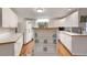 Bright kitchen with white cabinets and laminate flooring at 1610 Reynolds Rd # 159, Lakeland, FL 33801