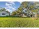 Large grassy backyard with mature trees and mobile home at 5342 Cooper Ln, Fort Meade, FL 33841