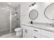 Modern bathroom with double vanity, granite countertop, and a large walk-in shower at 1312 Congo Dr, Poinciana, FL 34759