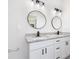 Bathroom boasts a double vanity with granite countertop and black matte fixtures at 1312 Congo Dr, Poinciana, FL 34759