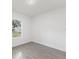 Simple bedroom with grey tile flooring and a window at 1312 Congo Dr, Poinciana, FL 34759