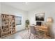 Bright home office features built-in shelving and a workspace with natural light at 1312 Congo Dr, Poinciana, FL 34759