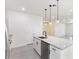 Modern kitchen with white cabinets, granite countertops, and stainless steel appliances at 1312 Congo Dr, Poinciana, FL 34759