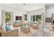 Bright and airy living room features wicker furniture and sliding glass doors leading to the backyard at 1312 Congo Dr, Poinciana, FL 34759