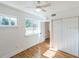 Well-lit bedroom, featuring wood floors and a closet at 25335 Troon Ave, Sorrento, FL 32776