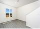 Bright living room with grey wood-look floors and large windows at 775 Poppy Ln, Dundee, FL 33838