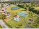 Aerial view of community with pool, tennis courts, playground, and pond at 2622 Montego Bay Blvd, Kissimmee, FL 34746
