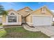 Attractive single-story home with a two-car garage and well-manicured lawn at 2622 Montego Bay Blvd, Kissimmee, FL 34746