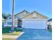 Attractive single-story home with a two-car garage and well-manicured lawn at 2622 Montego Bay Blvd, Kissimmee, FL 34746