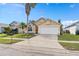 House exterior view, showcasing a driveway and landscaping at 2622 Montego Bay Blvd, Kissimmee, FL 34746