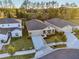 Aerial view of a house with a front yard and driveway at 33916 Sky Blossom Circle, Leesburg, FL 34788