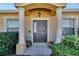 Dark brown front door with columns and landscaping at 1975 Country Manor St, Bartow, FL 33830