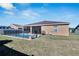 Tan house exterior with a fenced pool and backyard at 1975 Country Manor St, Bartow, FL 33830