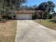 One-story home with attached garage and a red front door at 901 Hickory Rd, Ocala, FL 34472