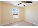 Well-lit bedroom with wood-look floors and a large window at 1714 Blossom W Cir, Lakeland, FL 33805